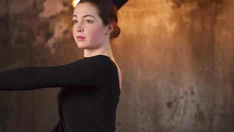 portrait-of-a-young-dancer,-who-rehearses-the-room-and-turns-around