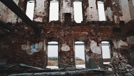 Inside-destroyed-orthodxal-cathedral,-red-bricks-walls,-cold-cloudy-day