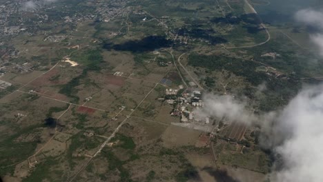 Airplane-flying-over-Mexico-landscape-clouds-summer