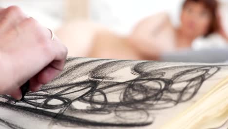 Hands-of-female-artist-draws-sketches-with-charcoal