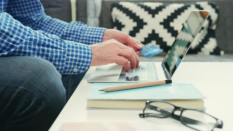 Businessman-Holding-Credit-Card-While-Typing-Numbers-On-Laptop-4K