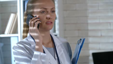 Young-Female-Doctor-Chatting-on-Mobile-Phone