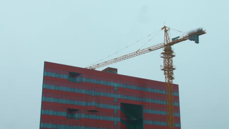 Big-tower-crane-working-on-construction-site.-Heavy-machinery-on-building-site