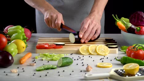 Chef-is-cutting-eggplant-in-the-kitchen