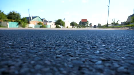 Blurred-cars-go-one-by-one-on-the-road.-Vehicles-drive-along-asphalt-road.-Traffic-in-highway.-Low-angle-view-Slow-motion