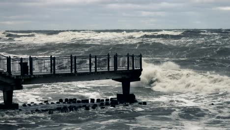 High-wave-breaking-on-the-rocks-of-the-coastline.-Stormy-weather-on-sea-with-big-wave-breaking-on-breakwater.-Slow-Motion.