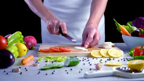 Man-is-cutting-vegetables-in-the-kitchen,-slicing-black-turnip