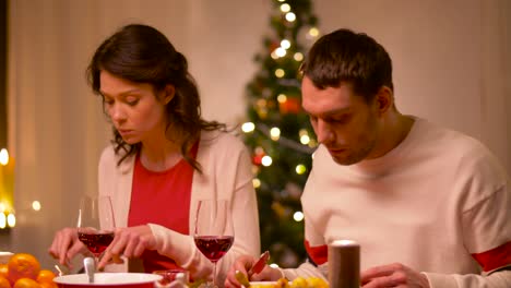 happy-couple-eating-at-christmas-dinner