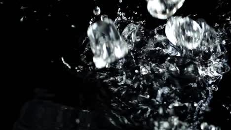 Falling-of-cubes-of-ice-on-a-black-background.-Slow-motion.