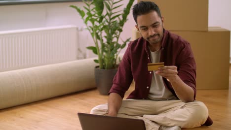 man-with-laptop-shopping-online-at-new-home