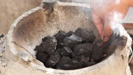 Firing-charcoal-in-thai-traditional-stove-with-pine-stick