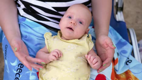 Baby-of-three-months-on-mothers-lap