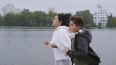 Mom-and-Son-Jogging-along-Riverside