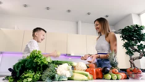 Kitchen-and-food.-Mom-and-son-are-playing-in-the-kitchen.