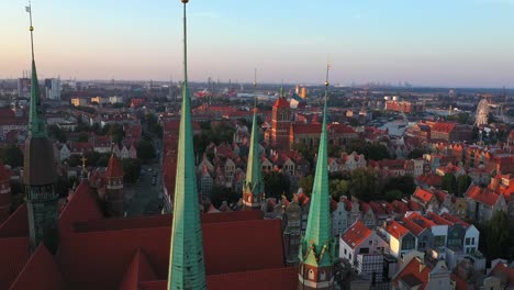 Gdansk-old-city-in-the-rays-of-the-rising-sun,-aerial-view-of-the-old-city-streets