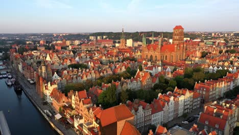 Gdansk-old-city-in-the-rays-of-the-rising-sun,-aerial-view-of-the-old-city-streets