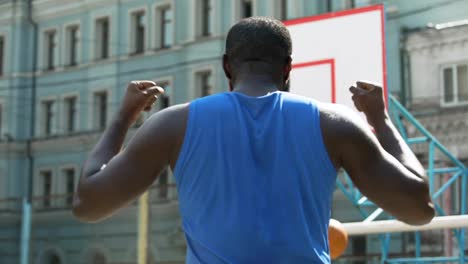 Motivated-Afro-American-person-throwing-ball-into-the-basket,-sports-hobby