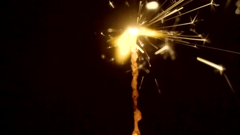 Firework-sparkler-burning-on-black-background-in-slow-motion