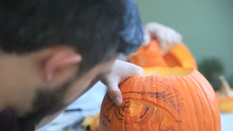 Two-men-carving-Halloween-pumpkins