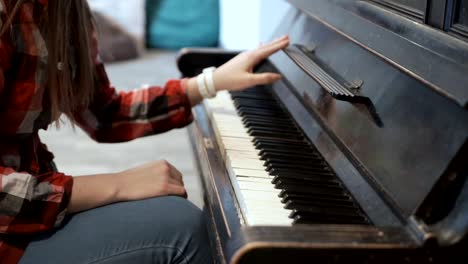 Female-gently-touches-music-stand-from-piano