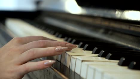 Woman-gently-touches-piano-keys