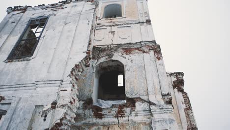 Old-destroyed-orthodoxal-cathedral-building,-piles-of-bricks-covered-in-snow