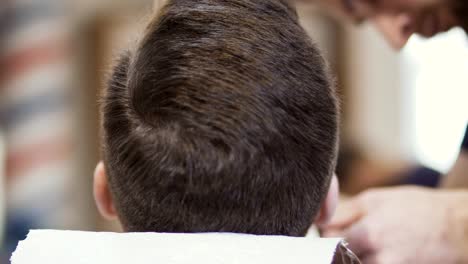 Professional-barber-makes-style-beard-to-a-customer-in-barbershop