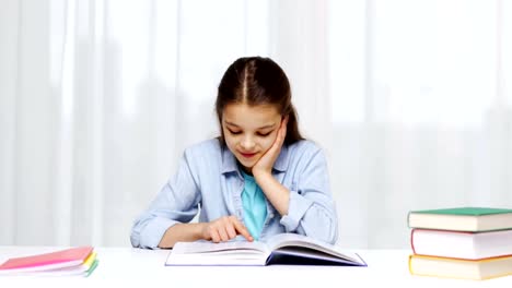 happy-school-girl-reading-book-or-textbook-at-home