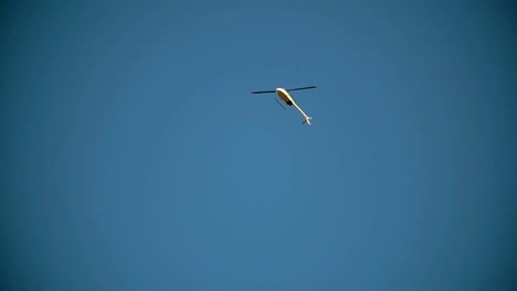 The-helicopter-flies-through-the-blue-sky-view-from-the-bottom-up