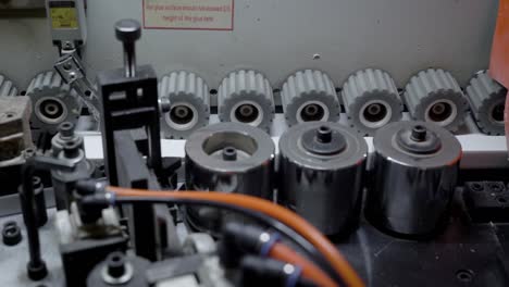 Close-up-shot-of-gears-rotating-in-a-edge-banding-machine