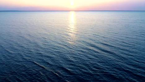 The-flight-above-the-water-on-the-picturesque-sunrise-background.-drone-shot