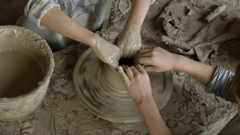 Hands-of-Children-Making-Pottery