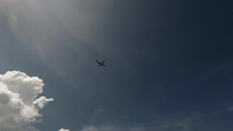 Passenger-plane-taking-off-overhead-through-blue-sky