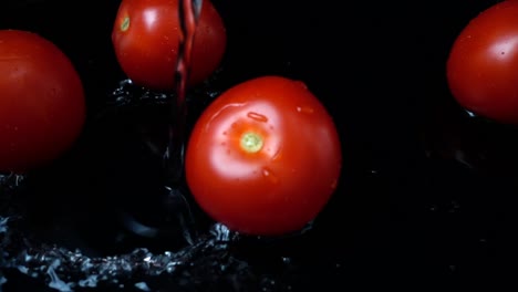 The-stream-of-water-flows-on-tomatoes.-Slow-motion.