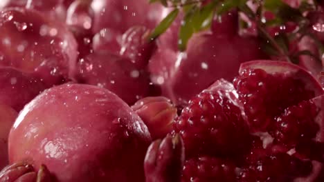 Pomegranate-falling-in-juice-with-splash-between-pomegranate.-Slow-motion