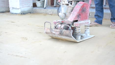 Worker-use-vibratory-plates-seals-the-base-sand