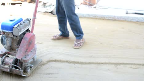 Worker-use-vibratory-plates-seals-the-base-sand