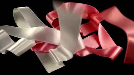 Satin-ribbon-on-a-black-background.-Slow-motion.