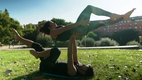 Beautiful-couple-practicing-acro-yoga-in-the-morning