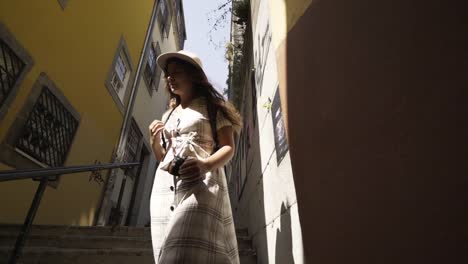 Woman-walking-down-stairs-between-buildings