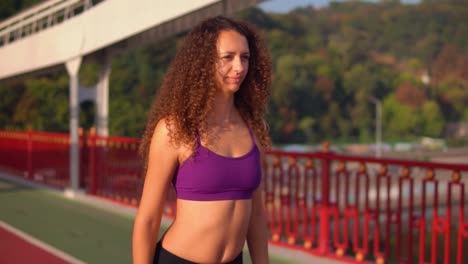 slim-girl-with-curly-hair-trains-in-city