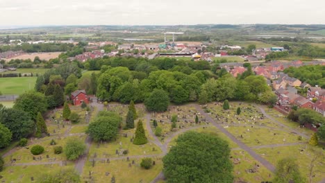 Aerial-footage-overlooking-the-British-town-of-Castleford-near-Wakefield-in-West-Yorkshire,-showing-rows-of-houses-and-fields-in-the-background,-taken-on-a-sunny-bright-summers-day.