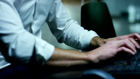 Male-hands-typing/working-on-laptop-keyboard-in-the-office-(Macro-Close-up)