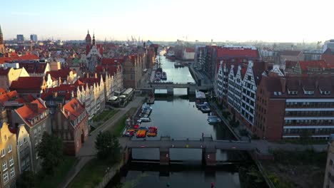 Gdansk-old-city-in-the-rays-of-the-rising-sun,-aerial-view-of-the-old-city-streets