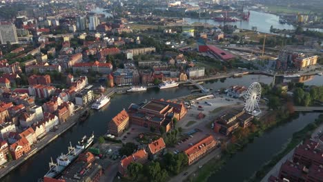 Gdansk-old-city-in-the-rays-of-the-rising-sun,-aerial-view-of-the-old-city-streets