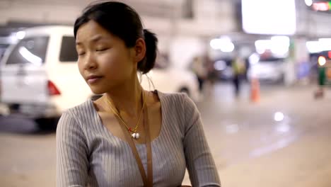 Smiling-Asian-woman-in-underground-car-parking