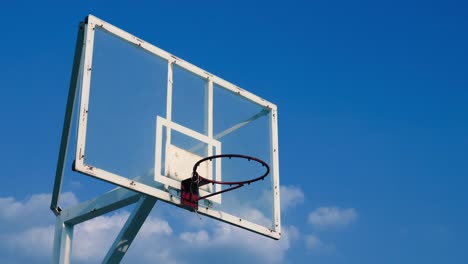 Basketball-cage-against-blue-sky-on-sunny-summer-day