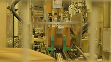 Folding-cardboard-boxes-on-a-conveyor-belt-in-a-rice-factory-–-4K