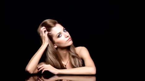 Beauty-female-video.-Blonde-woman-model-posing-at-mirror-table