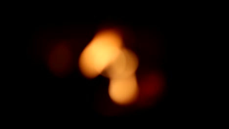 The-fire-in-the-fireplace-flame-at-black-background.-Out-of-focus-is-blurry.